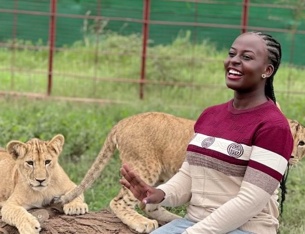 a woman chilling with lion at serval wildlife